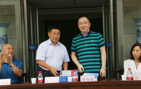 新乡市牧野区税务局党委书记、局长樊保峰向MILAN米兰体育·（中国）官方网站党委书记张会民赠送税法知识书籍.jpg